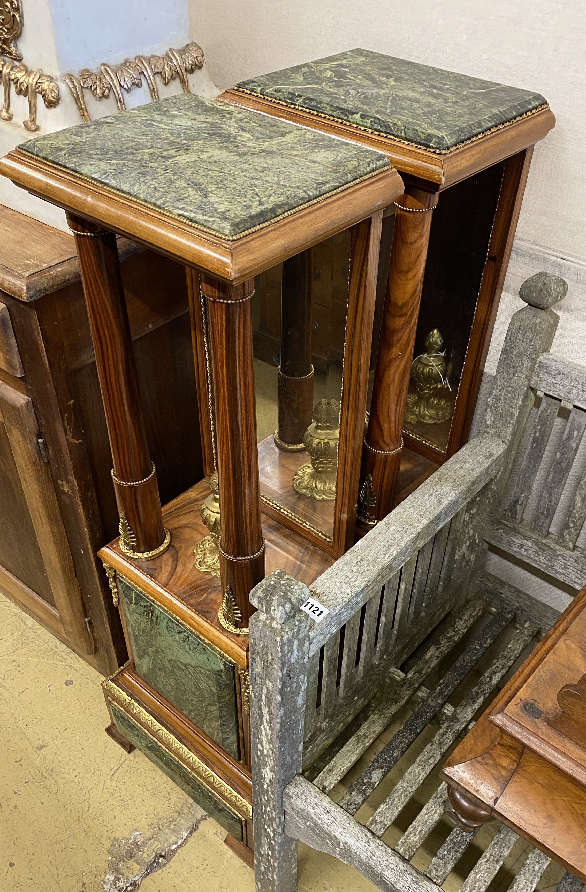 A pair of Empire style gilt metal mounted walnut mirrored pier tables, width 34cm, depth 24cm,