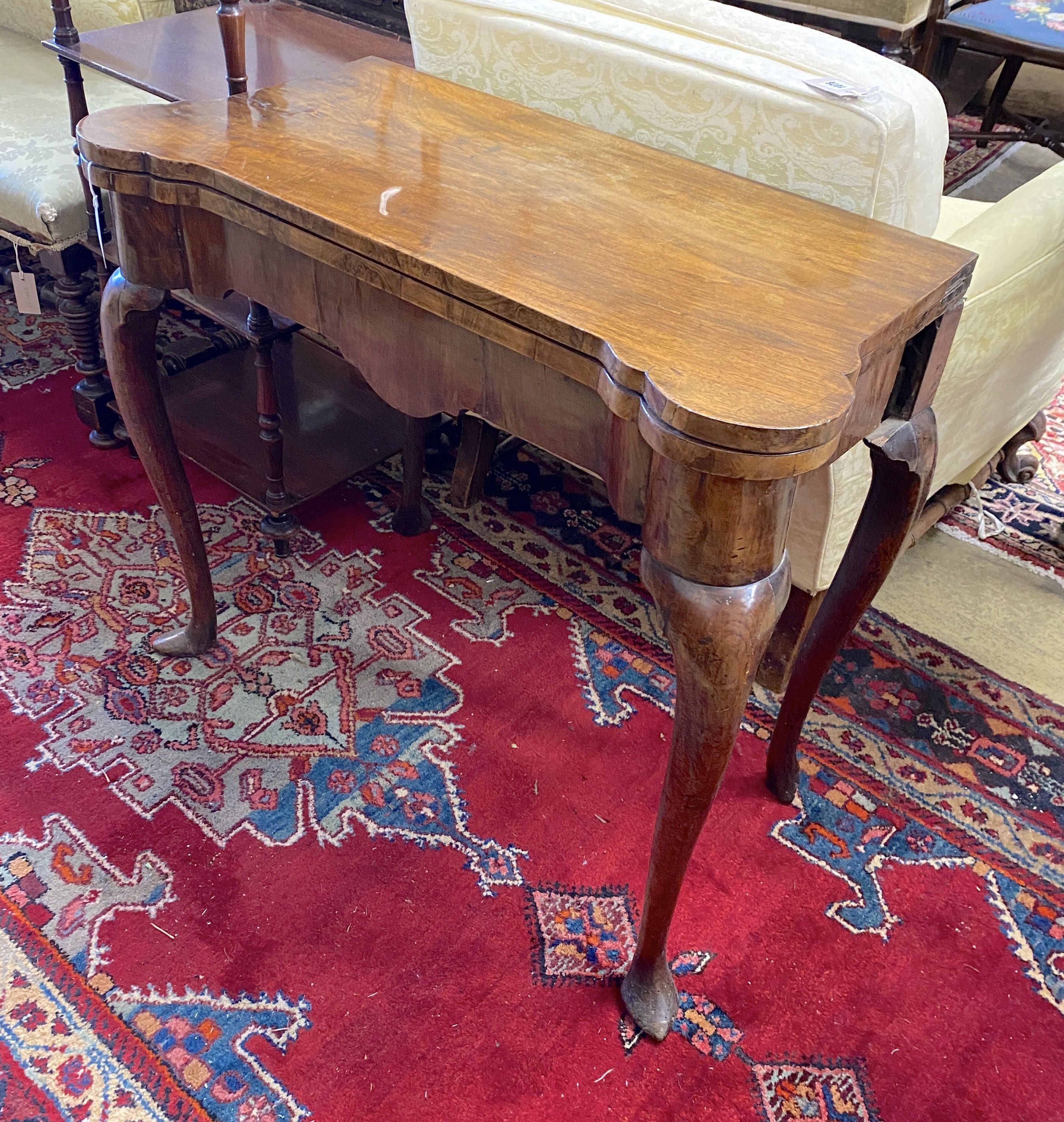 A mid 18th century walnut folding card table (a.f.), width 86cm, depth 42cm, height 73cm