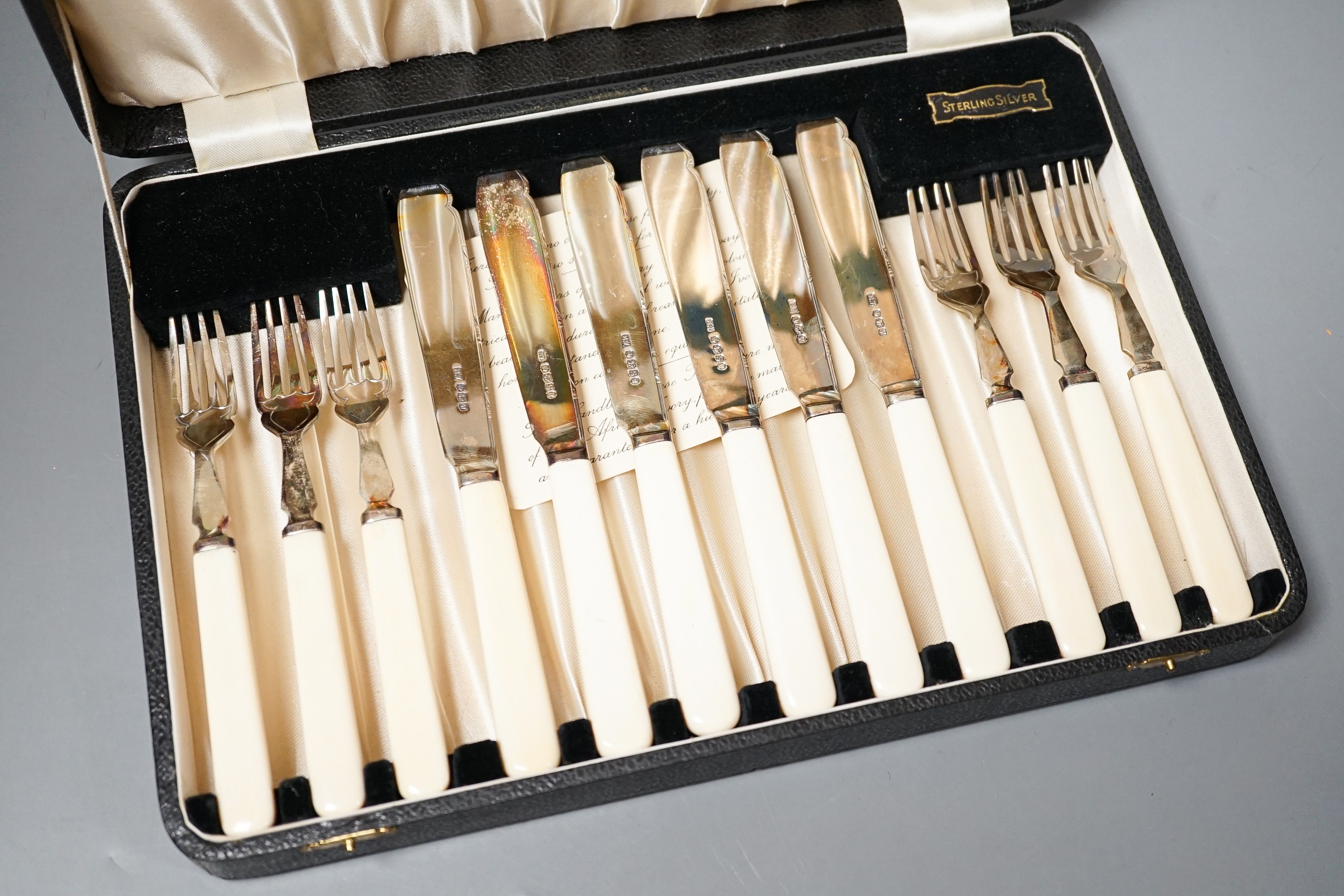 A 1930's cased set of six pairs of ivory handled silver dessert eaters by Viners Ltd, Sheffield,