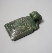 A Chinese spinach green jade belt hook, 19th century, in archaistic style, carved in relief with a
