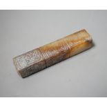 A Chinese archaistic white and russet jade handle mount, carved in relief with three registers of