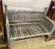 A small weathered teak slatted garden bench, length 114cm, depth 56cm, height 90cm