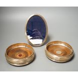 A pair of modern silver mounted wine coasters, W.E.V. London, 1990, (a.f.), 12.2cm and a 925 mounted