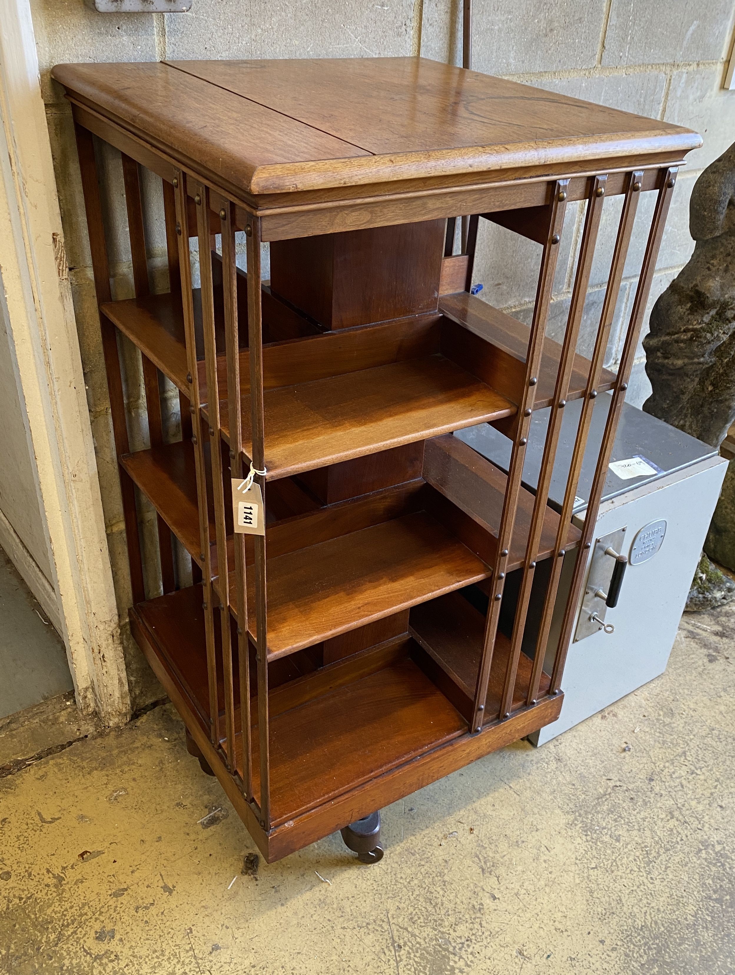 A large Edwardian pale oak revolving bookcase, width 59cm, depth 59cm, height 120cm