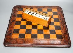 A late 19th century walnut, ebony and sycamore chessboard together with a box set of dominoes,