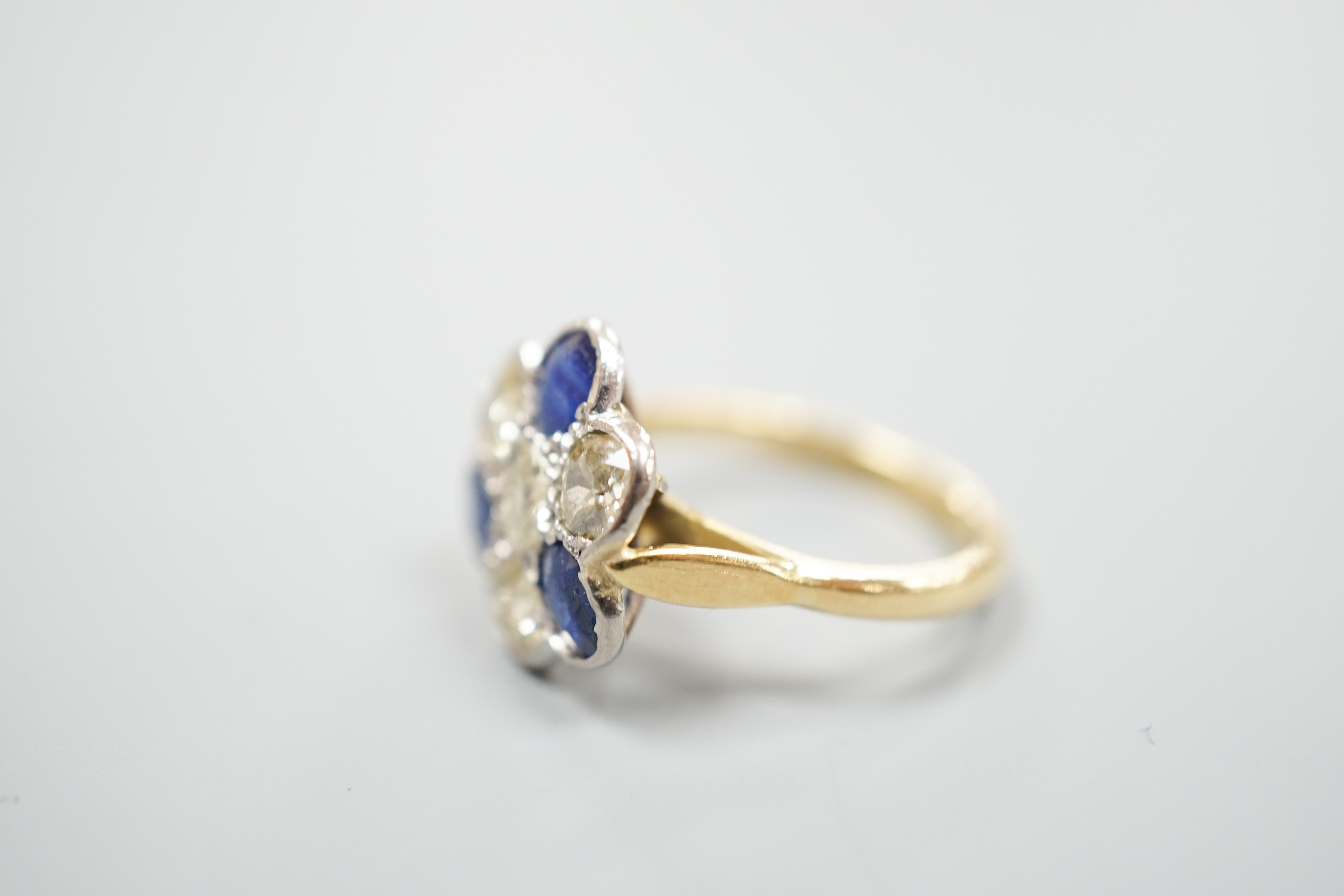 A modern 18ct gold, four stone diamond and three stone sapphire set flower head cluster ring, size - Image 3 of 4