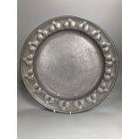 A near pair of Salzburg pewter wrigglework chargers, diameter 41cm, and six similar plates, 18th/