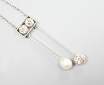 A 1940's white metal (probably platinum), three stone diamond and single stone teardrop shaped pearl