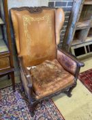 A 19th century French carved beech reclining armchair with original gilt leather upholstery, width