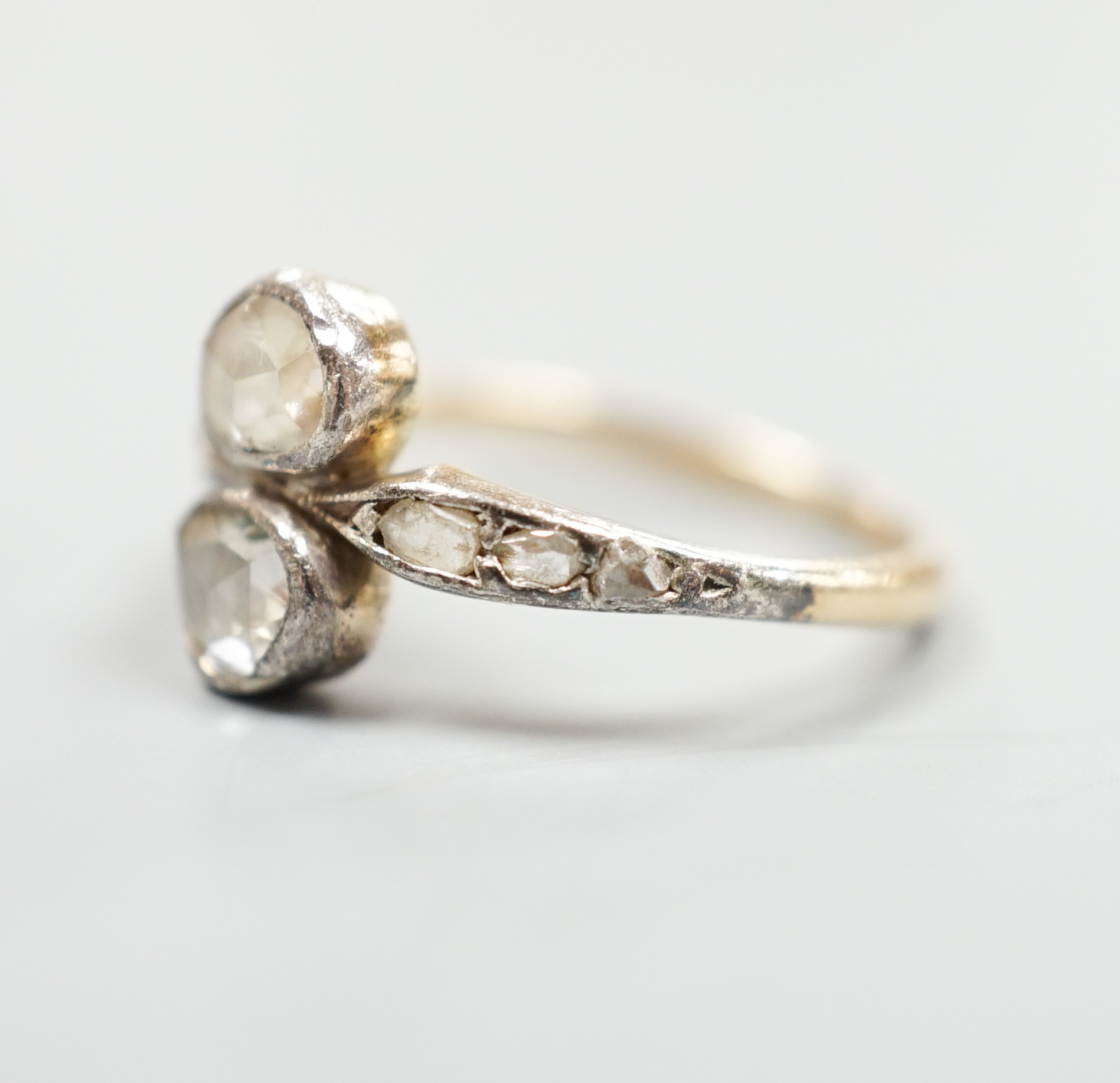 An antique yellow metal and two stone rose cut diamond set crossover ring, with diamond set - Image 2 of 4