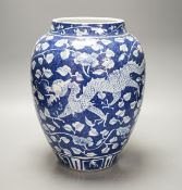 A Chinese blue and white ovoid jar, 19th/20th century, painted with dragons amid flowers and