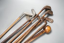 Golf clubs, knobkerrie in a leather carrier, carrier 50cms high.