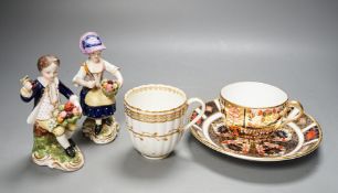 A Derby Imari saucer, a similar tea cup, a pair of Sampson Hancock, Derby figures, and a Derby