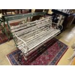 Three various painted wrought iron slatted wood garden benches, two in need of restoration,