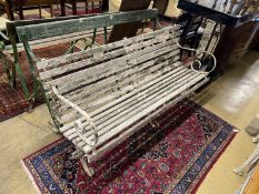 Three various painted wrought iron slatted wood garden benches, two in need of restoration,