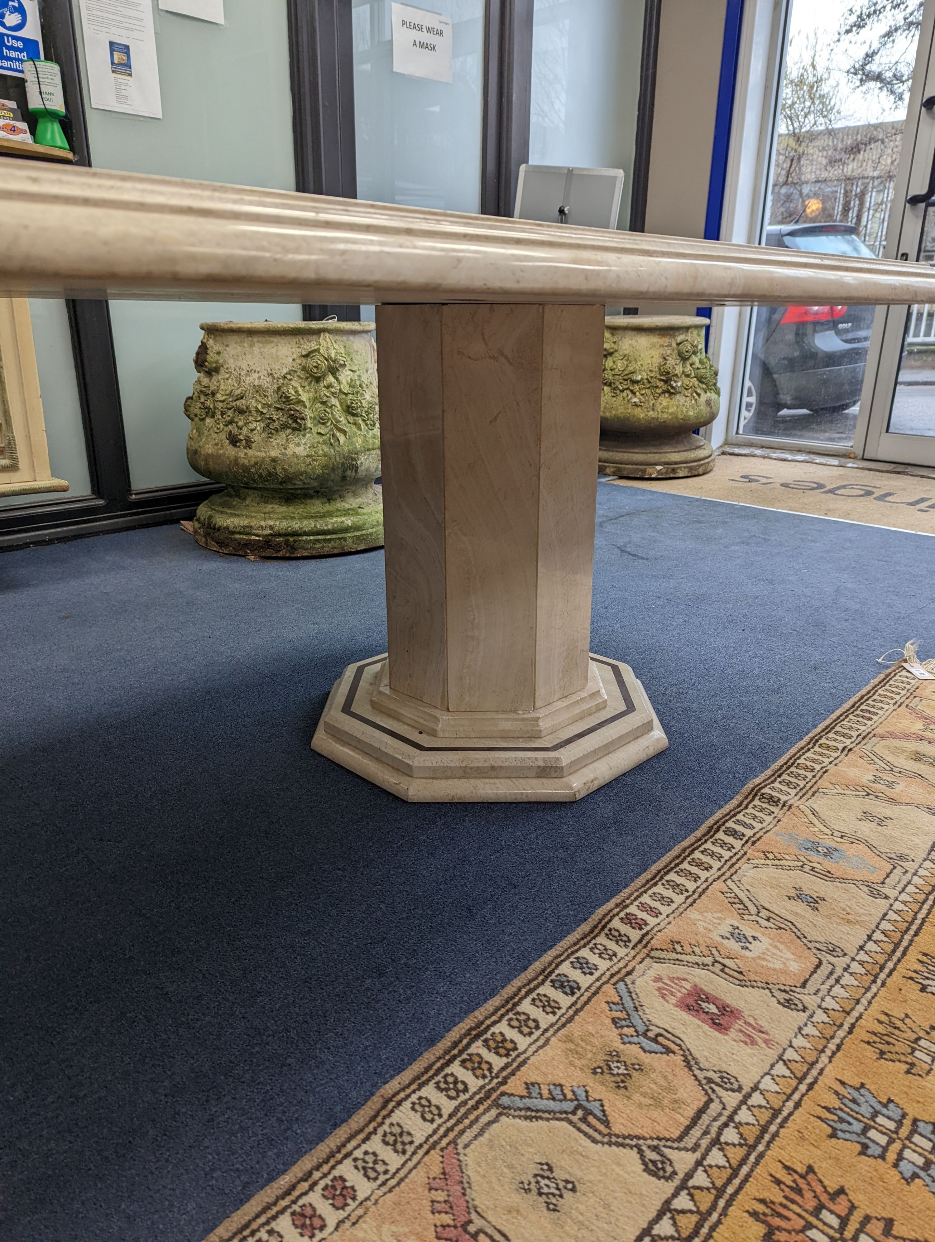 A Travertine marble dining table of elongated ocgtagonal form on twin octagonal column supports, - Image 7 of 7