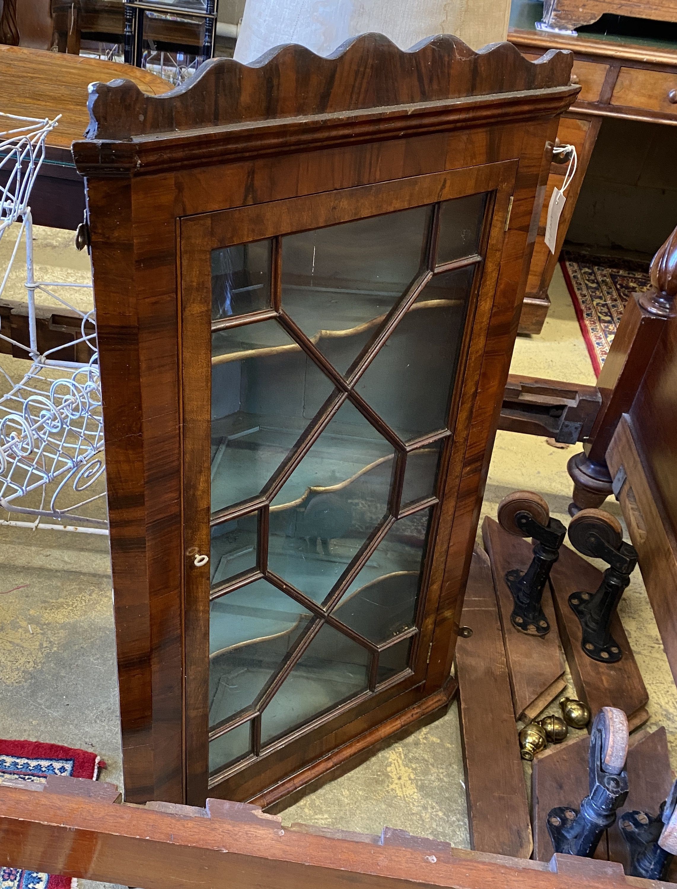 A George III walnut hanging corner cabinet, width 60cm, depth 28cm, height 102cm