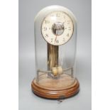 A Bulle electric pendulum clock, with large central brass pillar supporting the 14cm. dial, under