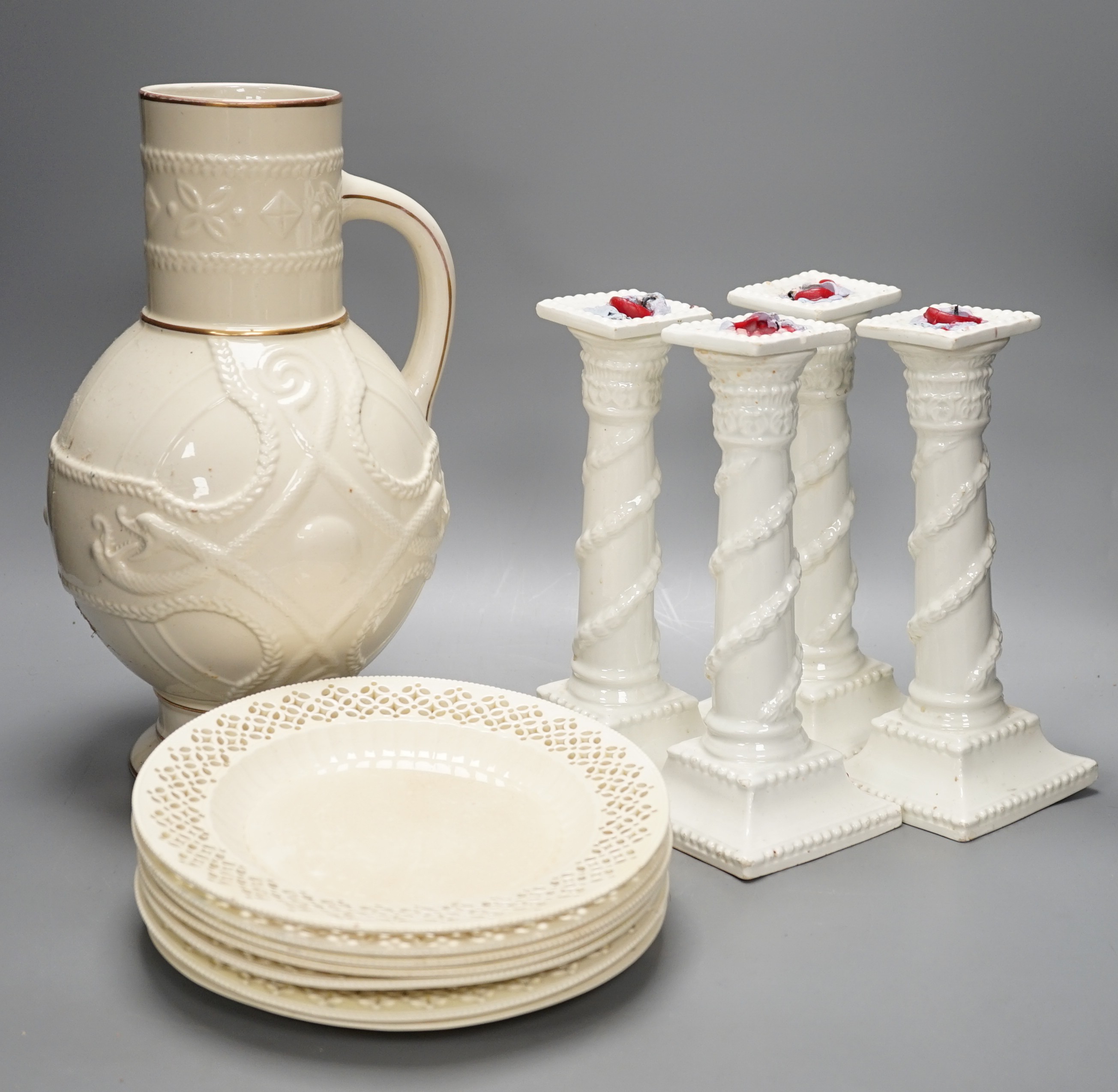 A set of seven early 19th century creamware plates, four later creamware candlesticks and an ivory