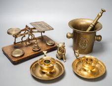 A quantity of bronze and brass wares including a pestle and mortar, candlesticks, coffee grinder