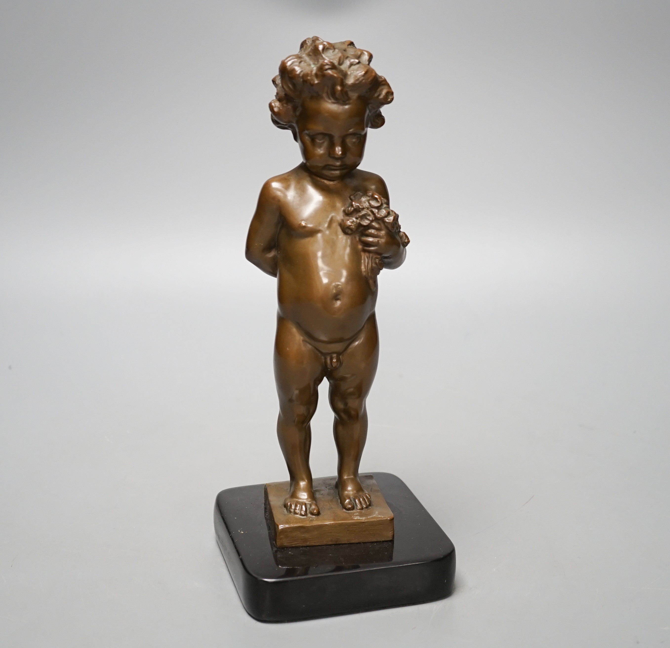 A bronze of a putto holding flowers, signed ‘M.Müller’ 25cm