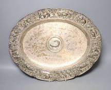 An Indian embossed white metal oval tray, with later engraved inscription and initials, 42.5cm,