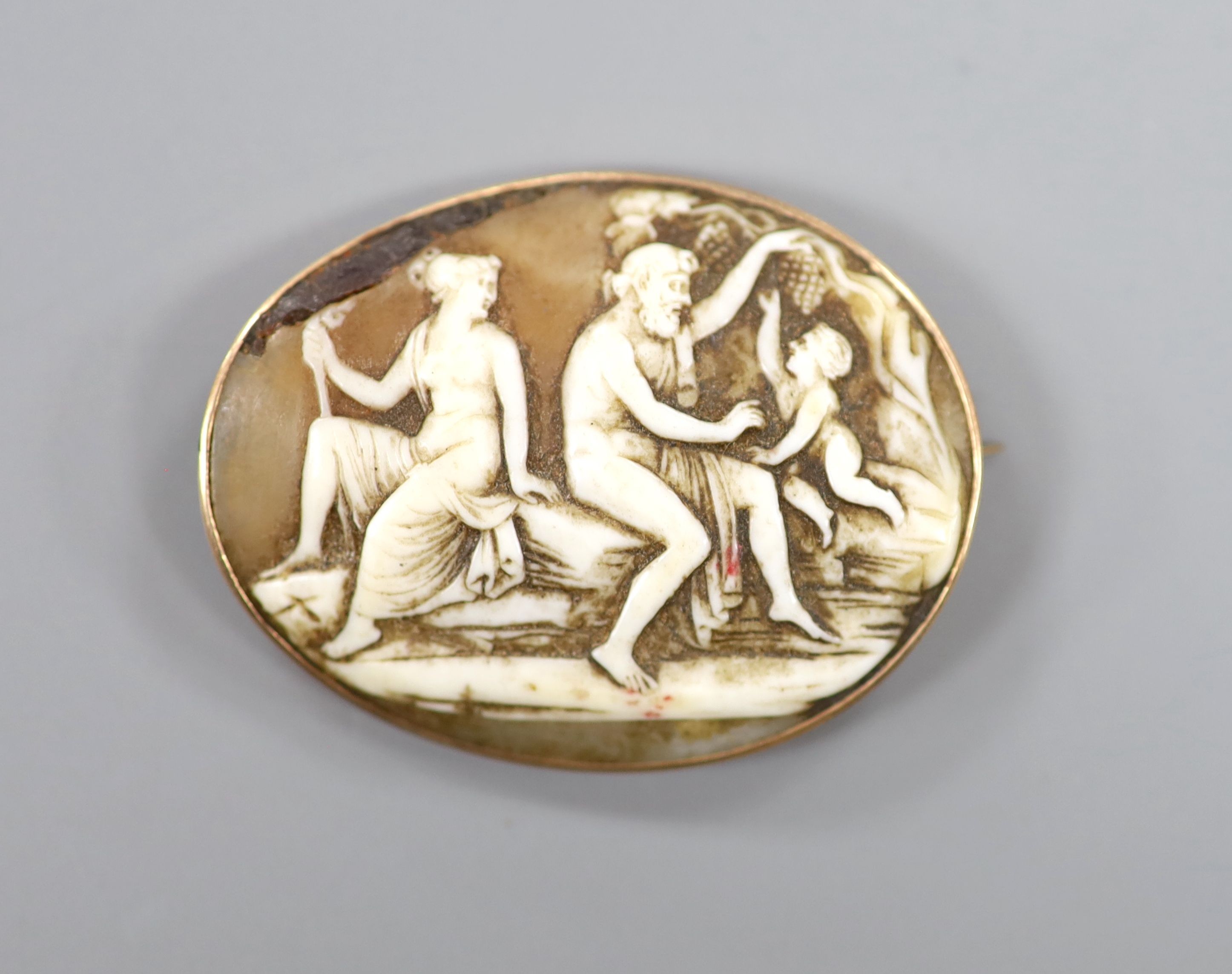 A yellow metal mounted antique oval cameo shell brooch, carved with classical figures, 4cm.