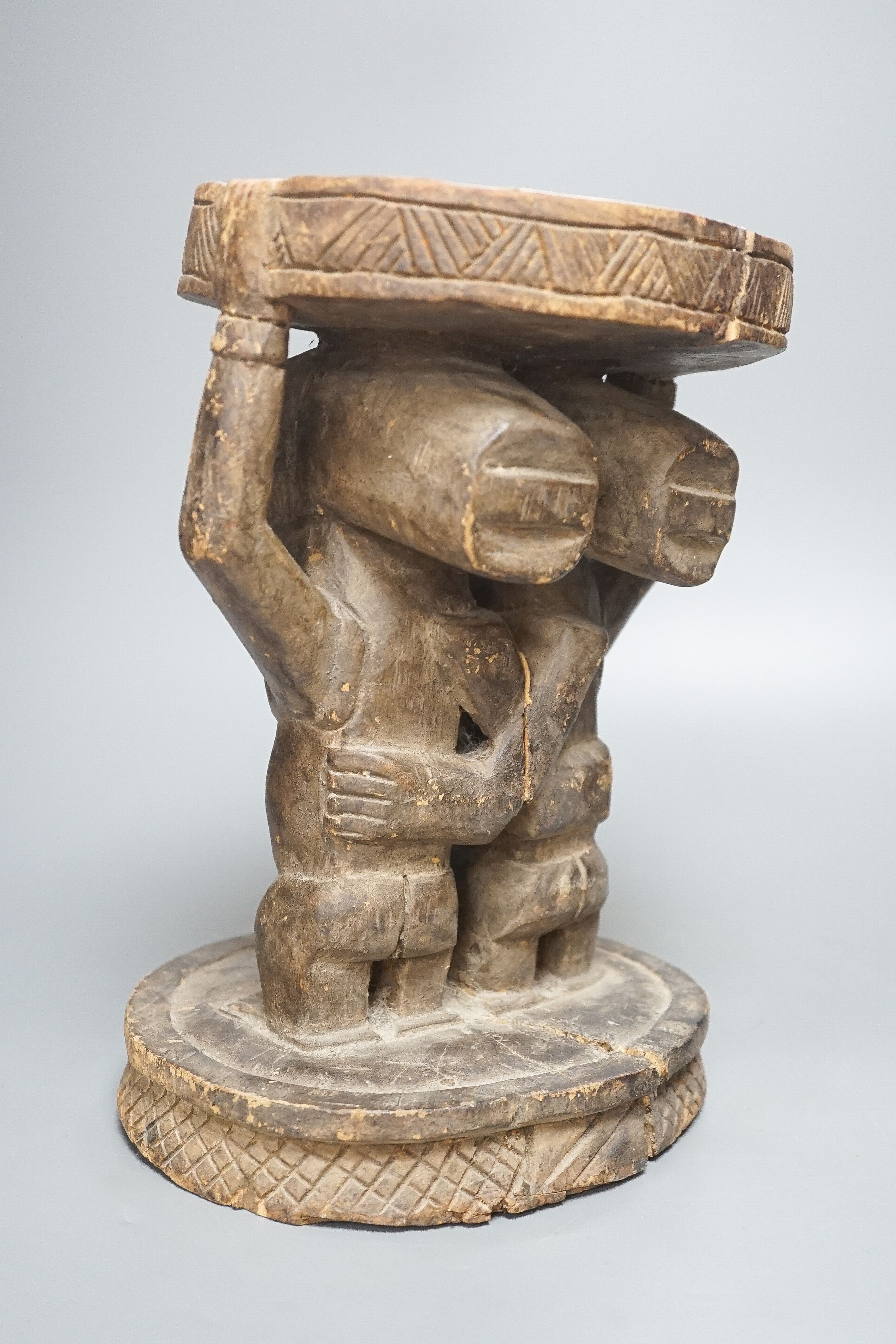 A Yoruba carved wood stool, modelled with male and female figures 27cm - Image 4 of 5