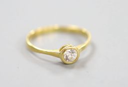 A yellow metal and collet set solitaire diamond ring, size P, gross weight 1.9 grams,the stone