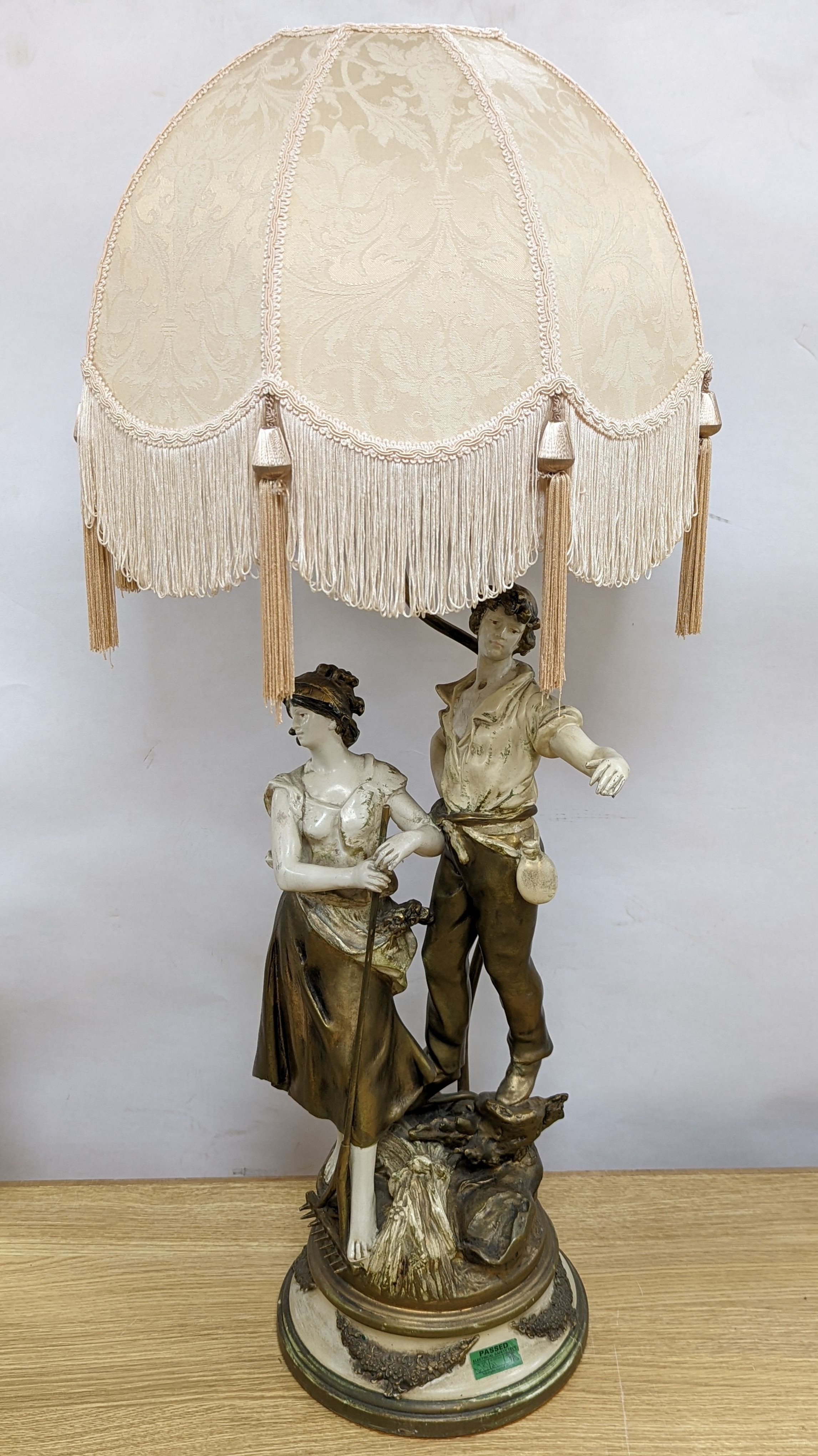 After L & F Moreau - a painted spelter figural table lamp, peasant girl and boy, 96 cms high