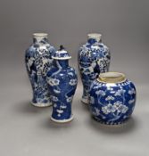 A pair of 19th century Chinese blue and white vases, a prunus vase and cover and a similar jar (