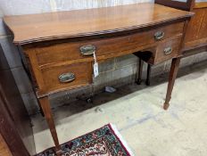 An Edwardian mahogany serpentine kneehole dressing table. W-106cm, D-53cm, H-79cm.