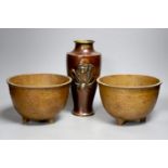 A Japanese bronze 'Daruma' vase and a pair of bronzed aluminium tripod bowls, vase 25 cms high.