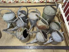 Ten vintage galvanised watering cans.