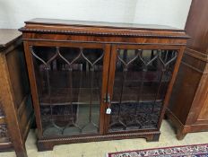 A 1920s mahogany low bookcase, in Chippendale style W-118cm, D-34cm, H-112cm.