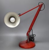 A red anglepoise table lamp, 79 cms high.