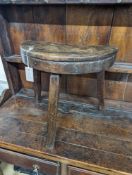 A 19th century primitive fruitwood stool. W-47cm, D-22cm, H-45cm.