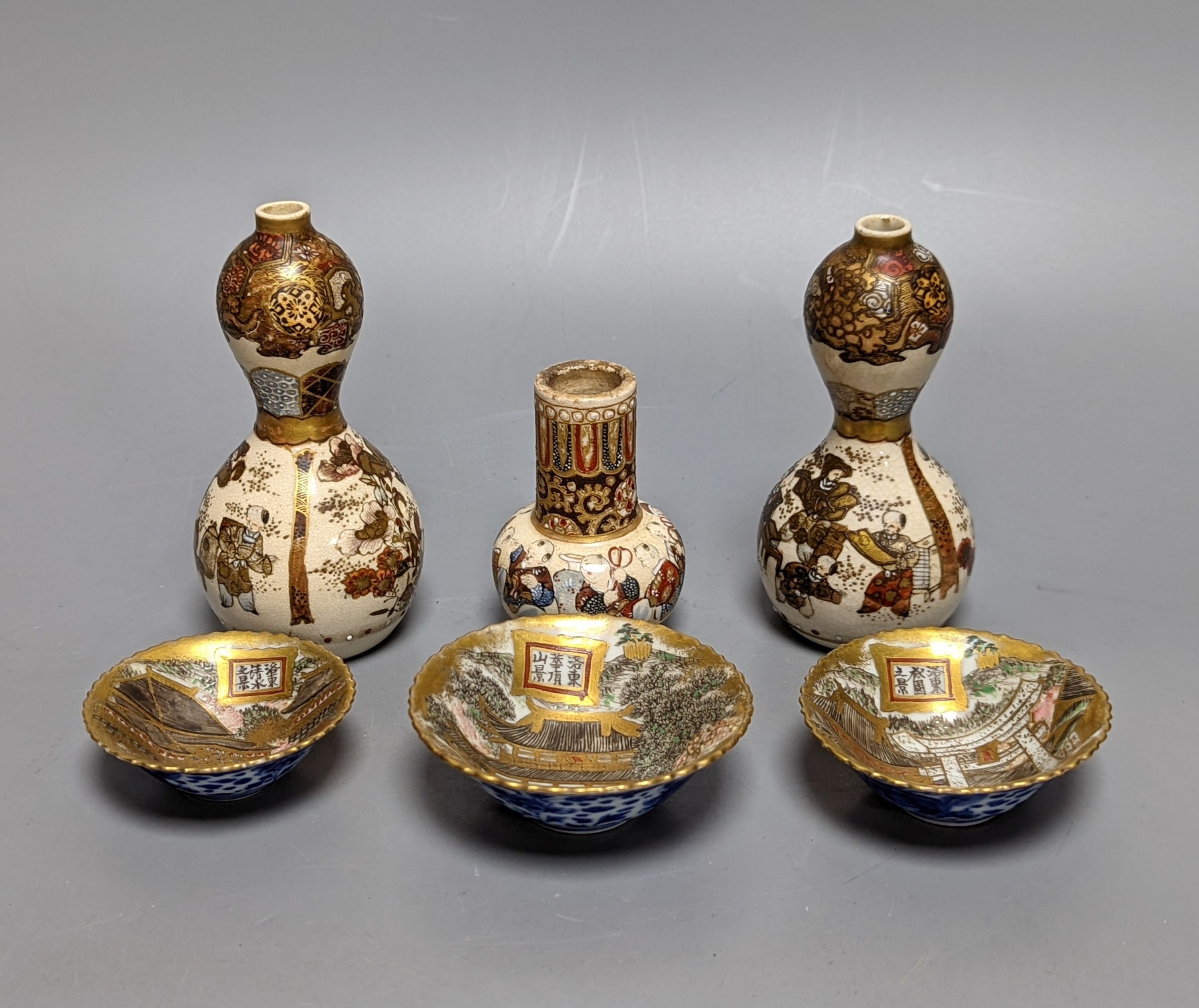 Three Japanese graduated porcelain miniature bowls, a pair of small Satsuma vases and another,