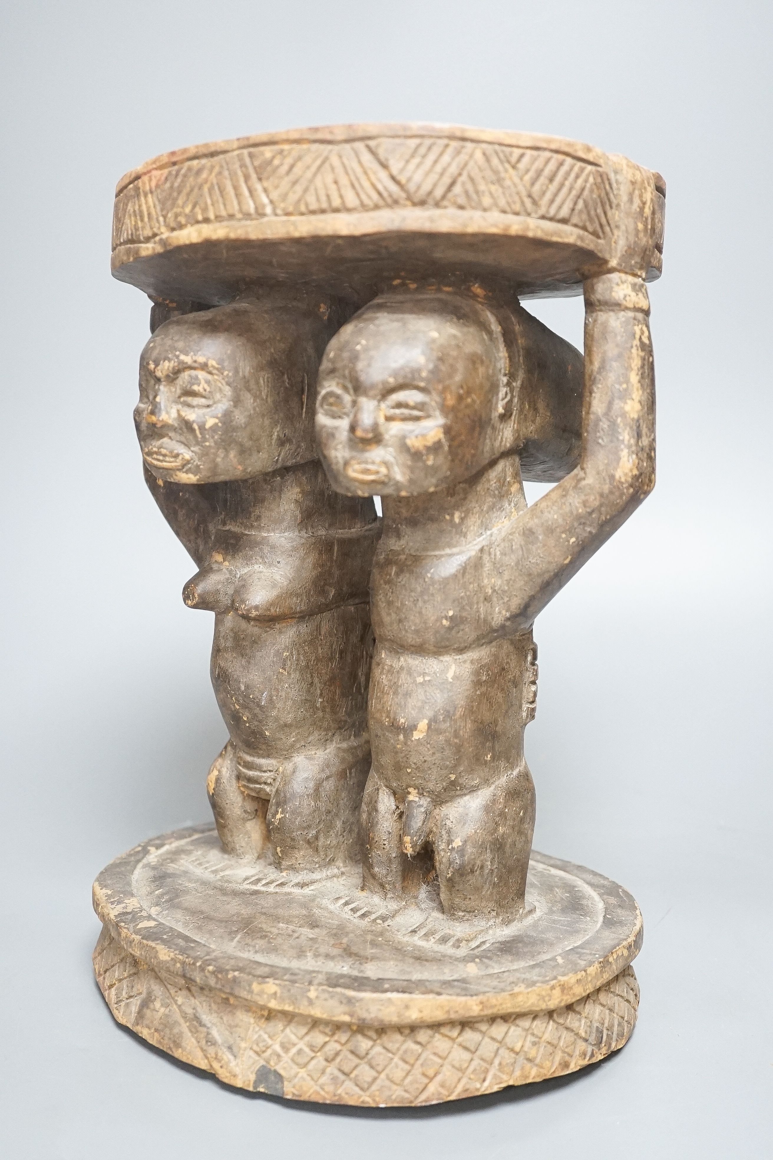 A Yoruba carved wood stool, modelled with male and female figures 27cm - Image 3 of 5
