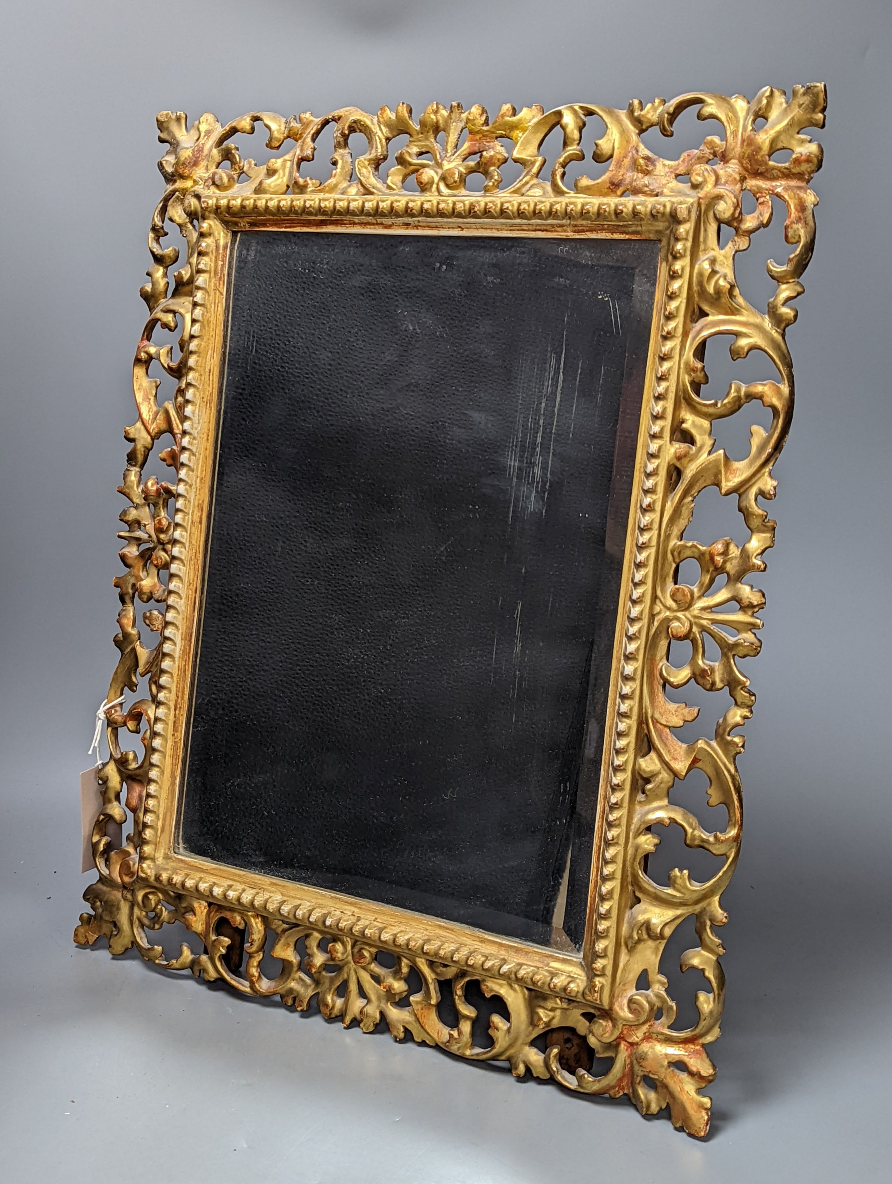 A Florentine giltwood framed mirror, with later easel back, 54 cms high x 43 cms wide.