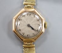 A lady's early 20th century yellow metal manual wind wrist watch, on a 9ct mesh link bracelet,