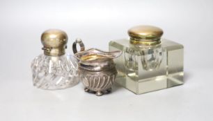 A late Victorian silver cream jug and two silver mounted glass inkwells.