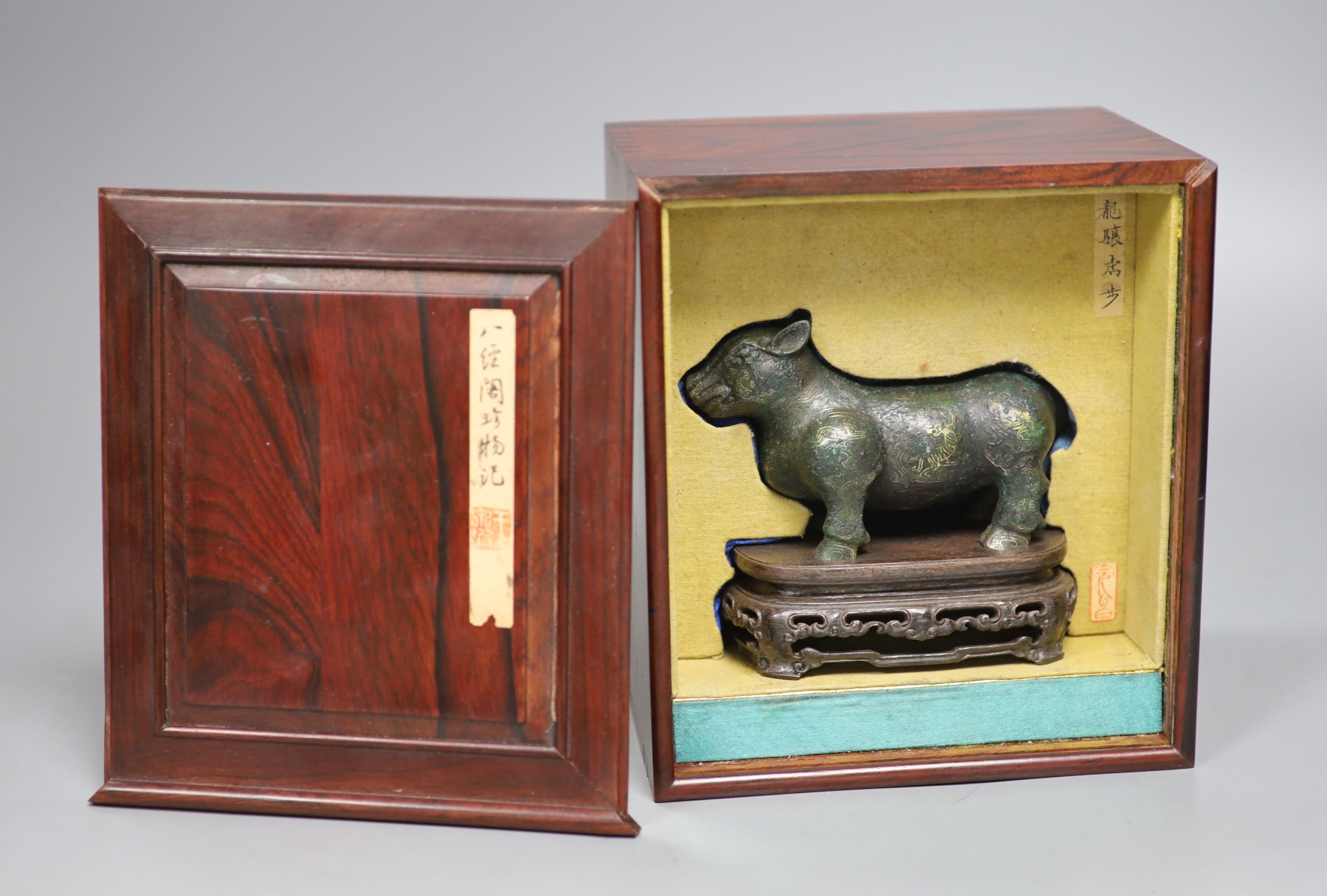 A Chinese gold and silver inlaid bronze figure of a tapir, Han dynasty or later, L. 12cm,
