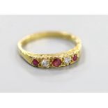 A modern 18ct gold, two stone diamond and three stone ruby half hoop ring, size O, gross weight 3.