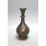 A Middle Eastern Islamic bronze vase, 28 cms high.