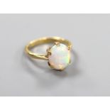 An 18ct and oval white opal set ring, size N, gross weight 3.6 grams.