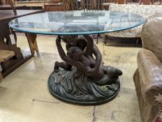 A bronzed composition glass top figures table. Diameter - 122cm, Height - 76cm.