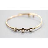 An antique yellow metal, rose cut diamond and pearl(untested) set bangle, gross weight 6.5 grams.