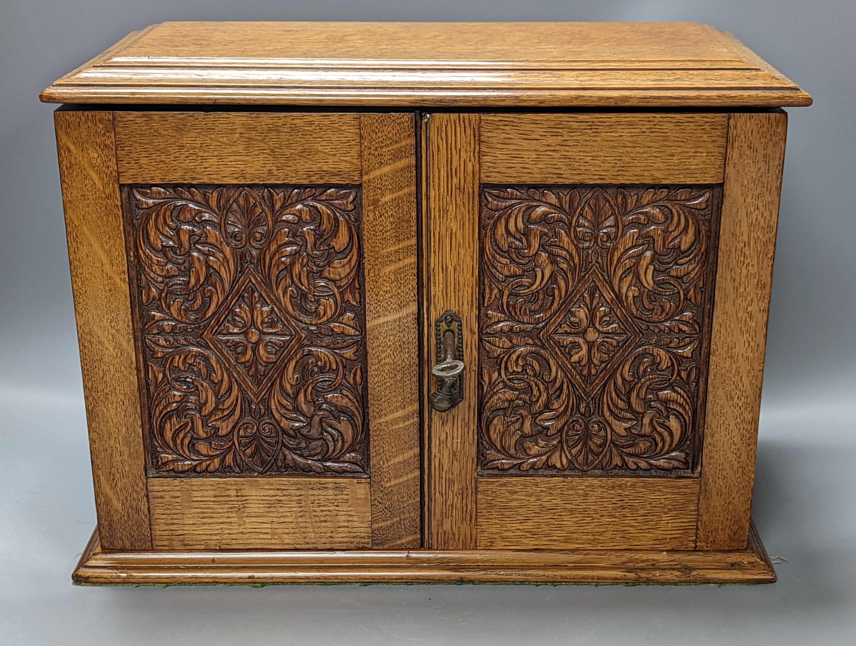 A carved oak smoker's cabinet 38cm