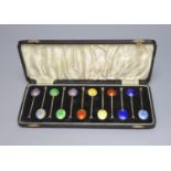 A cased set of twelve George V silver and polychrome enamel coffee spoons (enamel a.f.).